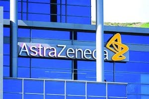 AstraZeneca logo on modern blue glass building exterior.